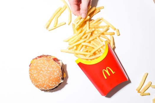 A top-down view of a classic burger and fries meal on a white background.